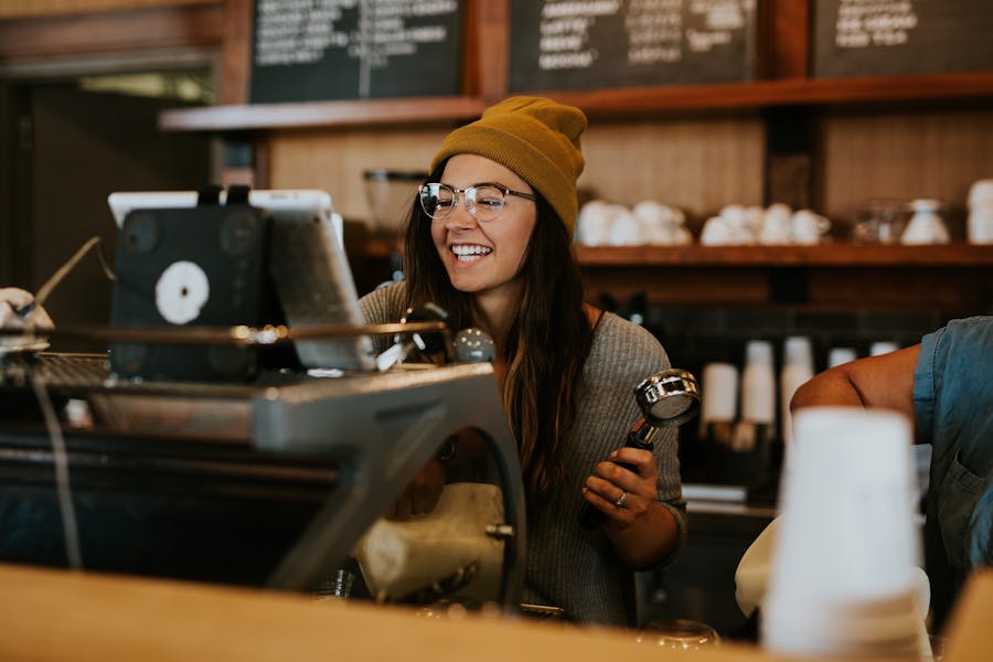 Happy female coffee shop worker
